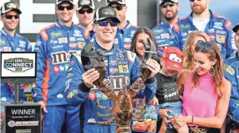  ?? BRIAN FLUHARTY, USA TODAY SPORTS ?? Kyle Busch holds up a lobster and celebrates his first-place finish in the ISM Connect 300 at New Hampshire Motor Speedway.