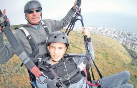  ??  ?? Rohan Bloom with his father, Rod, on a para-glider flight over the Atlantic seaboard.