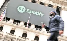  ?? — AFP file photo ?? A man walks by the New York Stock Exchange on the morning that Spotify begins trading shares at the NYSE on Apr 3, 2018 in New York City.