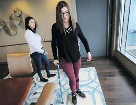  ?? DAN JANISSE ?? Madison Arseneault walks with a cane as her mother Shirley looks on at their lawyer’s office on Tuesday. Madison’s skull was impaled by a sawed-off golf club in 2016 during a school physical education class at the city-run Ford Test Track in Windsor.