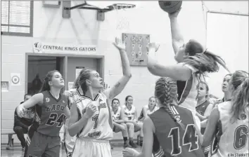  ?? KIRK STARRATT ?? Santanna Rafuse, of the Central Kings Gators, looks on with intensity in her eyes as teammate EmmaLee Harvey goes for a layup in the Senior Girls Gator Classic game against Cabot on Dec. 15. CK held the lead for most of the game before Cabot closed the gap, winning by a score of 58 to 46.