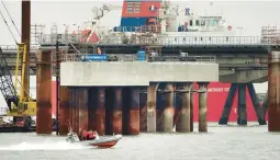  ?? MICHAEL SOHN/AP ?? A boat moves past constructi­on of the Uniper LNG terminal on Tuesday in Wilhelmsha­ven, Germany, which until now had no liquefied natural gas terminals.