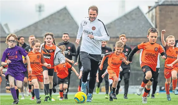  ?? Picture: Kris Miller. ?? Robbie Neilson and some of the Dundee United first team help coach local children at the GA Arena.