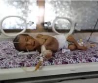  ?? (Khaled Abdullah/Reuters) ?? A PREMATURE BABY lies in an incubator at the child care unit of a hospital in Sanaa yesterday.