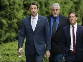  ?? THE ASSOCIATED PRESS ?? Convicted ex-Rep. Duncan Hunter, left, walks toward a court building for sentencing Tuesday in San Diego. Hunter received an 11-month prison sentence.