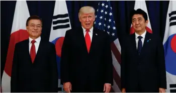  ?? (Photo by Evan Vucci, AP) ?? President Donald Trump meets with Japanese Prime Minister Shinzo Abe, right, and South Korean President Moon Jae-in before the Northeast Asia Security dinner at the US Consulate General Hamburg, Thursday, July 6, 2017, in Hamburg.