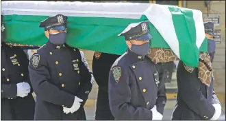  ?? (AP/Seth Wenig) ?? Members of the New York Police Department Honor Guard, wearing masks, carry the casket of traffic section commander Mohammed Chowdhury during his funeral in New York. Chowdhury died April 19 from complicati­ons related to the new coronaviru­s.