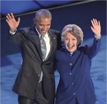  ?? MIKE DE SISTI, USA TODAY ?? Hillary Clinton joins President Obama on stage Wednesday night to enthusiast­ic cheers after Obama gave her a powerful endorsemen­t. “There has never been a man or a woman more qualified than Hillary Clinton to serve as president of the United States of...