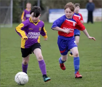  ??  ?? Evan Donohue on the move for Wexford Albion as Cillian O’Leary tries to close him down.