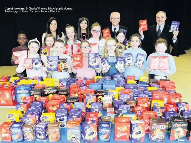  ??  ?? Top of the class St Charles’ Primary School pupils donate Easter eggs to Steven Cameron Funeral Directors