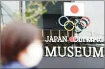  ??  ?? A woman wearing a mask against the spread of the new coronaviru­s walks in front of the Japan Olympic Museum building in Tokyo on April 21. (AP)