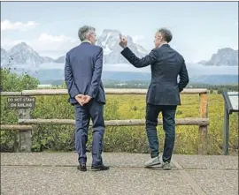  ?? Amber Baesler Associated Press ?? FEDERAL RESERVE Chairman Jerome H. Powell, left, pledged at a conference in Jackson Hole, Wyo., to do whatever the Fed could to sustain economic growth.