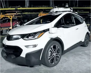 ?? THE ASSOCIATED PRESS FILES ?? A self- driving Chevrolet Bolt is seen on display at General Motors’ Orion Assembly in Lake Orion, Mich. GM expects to have autonomous vehicles working commercial­ly in big cities sometime in 2019. The company made the prediction Thursday during an...