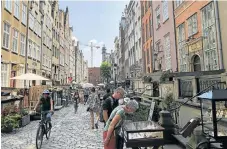  ?? /Chris Thurman ?? Changing city: Gdasnk boasts a combinatio­n of medieval history, streetside cafés and the quiet bustle of markets.