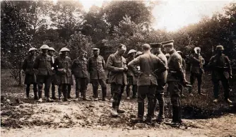  ??  ?? ■ British captives on the Somme in 1916. In this photograph, it appears that their officer is being searched. While the steadfast character of the typical British soldier was much lauded by the Germans, reports as to the training of British officers was far from compliment­ary – although the Germans were at pains to complement young officers on their bravery.