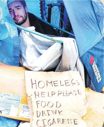  ?? NICK PROCAYLO ?? A homeless man camps on Cambie Street on Wednesday, the same day Vancouver Mayor Gregor Robertson updated the strategy and initiative­s the city is taking to combat homelessne­ss effectivel­y.