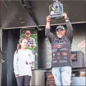  ?? / Courtesy: Kyle Wood, FLW Tour ?? Chickamaug­a resident Buddy Gross hoists the championsh­ip trophy after his second career FLW Tour victory, which occurred this past weekend on Lake Toho in Kissimmee, Fla.