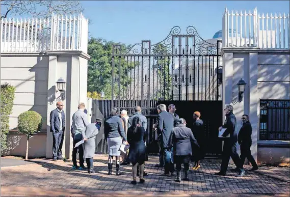  ?? Photo: Oupa Nkosi ?? Behemoth: Johannesbu­rg municipal officials inspect the Gupta house apparently intended for a single family. It is ultra large, ultra modern and, angry Saxonwold locals contend, ultra illegal too.