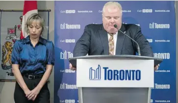  ?? CHRIS YOUNG/THE CANADIAN PRESS ?? Mayor Rob Ford stands with his wife Renata at a news conference in Toronto’s city hall on Thursday. He told reporters he is receiving help from health care profession­als and said he was suing former staffers for ‘lying’ about his drug use.