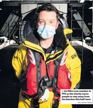  ?? Don Jackson-Wyatt ?? > An RNLI crew member in PPE as the charity warns people to stay away from the beaches this half-term