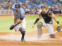  ?? TNS FILE ?? Baltimore catcher Caleb Joseph watches as Tampa Bay’s Mallex Smith scores Sept. 9. The Orioles were 44-108 through Wednesday.