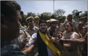  ?? (AP/Altaf Qadri) ?? Security personnel detain supporters of the Aam Admi Party, or Common Man’s Party, during a protest against the arrest of their party leader Arvind Kejriwal in New Delhi on Saturday.