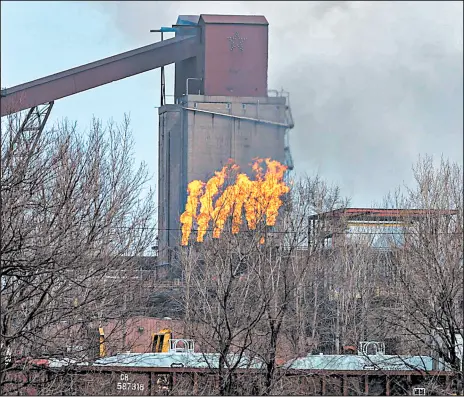  ?? JIM KARCZEWSKI/POST-TRIBUNE ?? Gases from steel coke processing are burned off at the ArcelorMit­tal Steel plant in Burns Harbor.