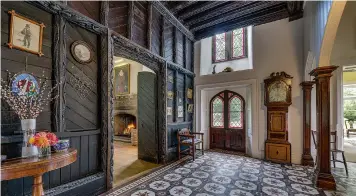  ?? ?? Below: The elaborate carved wood panelling is a highlight of the grand entrance hall