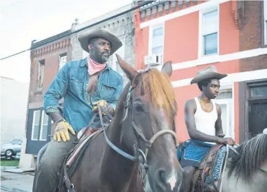  ?? Concrete Cowboy. Images / Netflix via AP ?? Idris Elba (left) and Caleb McLaughlin play father and son in