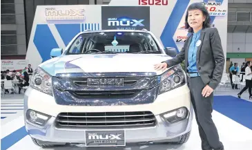  ??  ?? Mrs Panatda stands next to the Isuzu Mu-X Blue Power during last month’s Bangkok Internatio­nal Grand Motor Sale at Bitec.