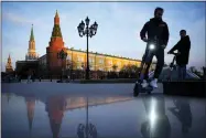  ?? AP PHOTO/ALEXANDER ZEMLIANICH­ENKO, FILE ?? FILE - Youth ride scooters in Manezhnaya Square near Red Square and the Kremlin after sunset in Moscow, Russia, on April 20, 2022. Russia staved off a default on its debt Friday, April 29, 2022, by making a last-minute payment using its precious dollar reserves sitting outside the country, U.S. Treasury officials said.