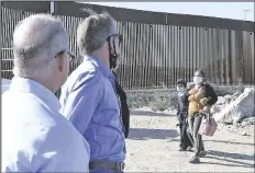  ??  ?? A YOUNG BOY AND WOMAN from Guatemala enter the United States illegally Tuesday morning in front of U.S. Representa­tive Paul Gosar (second from left), (R-AZ 4th District). Gosar was visiting the wall with Anthony Foti (left), Gosar’s communicat­ions director, and Thomas Van Flein (to the right of Gosar), Gosar’s chief of staff.