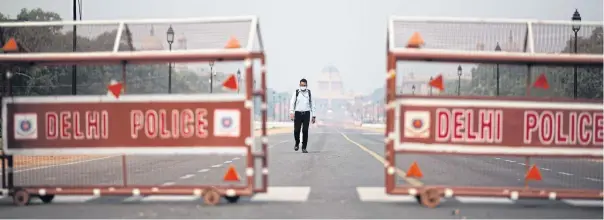  ?? AFP ?? A man walks on a deserted path leading to the Presidenti­al Palace during a government-imposed lockdown as a preventive measure against Covid-19 in New Delhi yesterday.