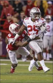 ?? NATI HARNIK — THE ASSOCIATED PRESS ?? Ohio State running back Mike Weber is tackled by Nebraska defensive back Joshua Kalu during the first half in Lincoln, Neb., on Oct. 14.