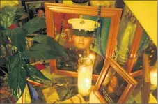  ?? Glenn Koenig Los Angeles Times ?? A SMALL MEMORIAL honors Peralta at his family’s home in San Diego in December 2004. His younger brother also is a Marine.