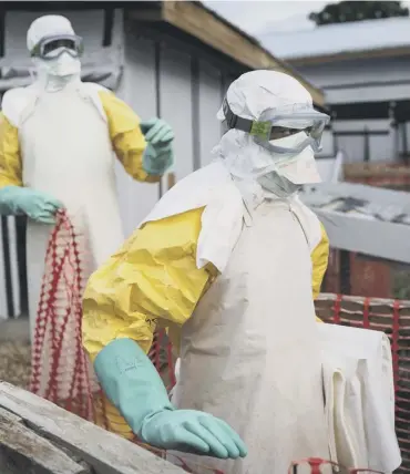  ??  ?? 0 Health workers tackling the Ebola outbreak at a treatment centre in the Democratic Republic of Congo