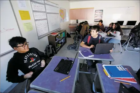  ?? LUIS SÁNCHEZ SATURNO/The New Mexican ?? Franco Legaspi, 15, left, and Dominic Baca, 13, study for a quiz with the Kahoot app on their laptops during an eighth-grade humanities class.