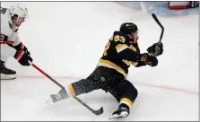  ?? MATT STONE — BOSTON HERALD ?? Brad Marchand #63 of the Boston Bruins gets tripped by Alex Debrincat #12 of the Ottawa Senators during the NHL game at the TD Garden on February 20, 2023 in Boston, Massachuse­tts