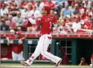  ?? JOHN MINCHILLO — THE ASSOCIATED PRESS ?? The Reds’ Scooter Gennett follows through on a two-run home run off Zach Eflin in the third inning of Sunday’s game.