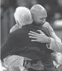  ?? BILL HABER/AP ?? Monty Williams, right, then coach of the Hornets in 2013, hugs Spurs coach Gregg Popovich after a game in New Orleans.