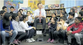  ?? CHRIS YOUNG/THE CANADIAN PRESS ?? Federal Finance Minister Bill Morneau spoke with students from Toronto’s Rose Avenue Junior Public School before a pre-budget photo opportunit­y in Toronto on Friday.