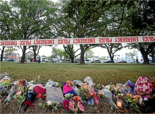  ?? GETTY IMAGES ?? Flowers are laid in Hagley Park in Christchur­ch, where the Bangladesh cricketers were scheduled to play New Zealand in the third test that was abandoned in the wake of the msoque shooting.