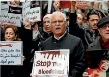  ?? PHOTO: AP ?? Former Syrian opposition leader George Sabra, centre, chants slogans as he joins others protesting attacks on the rebel-held suburb of Eastern Ghouta in Syria’s capital, Damascus, during a rally outside the Russian Consulate in Istanbul, Turkey.