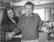  ?? CP PHOTO ?? Nelson Smith, right, father of Canadian death row inmate Ronald Smith, holds a photo of Ronald taken in the early 1980’s as Ronald’s daughter Carmen looks on in Red Deer, Alta., on Thursday. Ronald Smith’s father still had a bedroom and a vintage car...