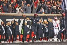  ?? AP PHOTO/AARON DOSTER ?? Cincinnati quarterbac­k Desmond Ridder celebrates after catching a touchdown pass during the second half against SMU on Nov. 20 in Cincinnati. Cincinnati won 48-14.