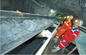  ??  ?? PHILEX MINING engineers check crushed ore transporte­d in a conveyor belt from the tunnel under Mt. Santo Tomas, Benguet.