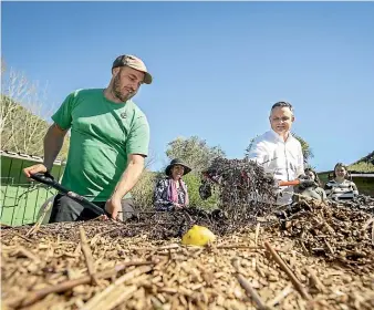  ?? VIRGINIA WOOLF/STUFF ?? Nelson Community Compost owner Ben Bushell, left, and Green Party co-leader James Shaw turn over compost.