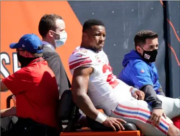  ?? AP Photo/Nam Y. Huh ?? New York Giants running back Saquon Barkley (26) is carted to the locker room after being injured during the first half of an NFL football game against the Chicago Bears in Chicago, on Sunday.