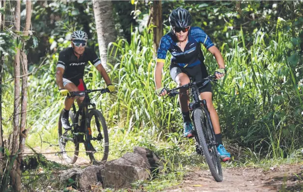  ?? Picture: STEWART McLEAN ?? FIT FUN: Redlynch’s Pascal Levieille and his son Kaito, 14, riding at the Smithfield Mountain Bike Park, are enthusiast­ic supporters of major events like the UCI Mountain Bike World Championsh­ips in Cairns.