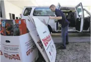  ?? Lynne Sladky / Associated Press ?? Staff Sgt. Brian Spittler loads a vehicle at the Marine Corps Toys for Tots depot in Hialeah, Fla.